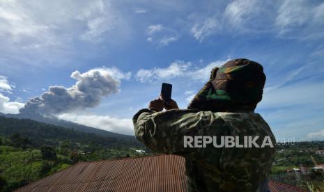 Petugas TNI memotret Gunung Marapi yang mengeluarkan abu vulkanik saat erupsi di Batang Silasiah, Nagari Bukik Batabuah, Agam, Sumatera Barat, Jumat (19/1/2024). Pemerintah setempat menetapkan status siaga darurat hingga 24 Januari 2024 agar bisa memaksimalkan penanganan warga yang berada di zona bahaya Gunung Marapi. 