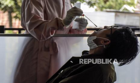 Calon penumpang pesawat terbang menjalani tes usap PCR di Bandara Husein Sastranegara, Kota Bandung, Selasa (26/10). Pemerintah berencana menjadikan tes PCR syarat wajib perjalanan untuk pengguna semua moda transportasi guna mencegah lonjakan kasus Covid-19 jelang libur Natal dan tahun baru (Nataru). Foto: Republika/Abdan Syakura