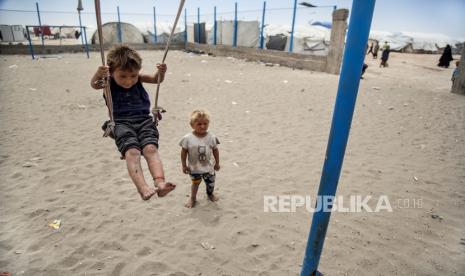 Seorang anak laki-laki bermain ayunan di kamp al-Hol, yang menampung keluarga anggota kelompok Negara Islam, di provinsi Hasakeh, Suriah, Sabtu, 1 Mei 2021. Sekitar 100 ribu anak Suriah diprediksi akan kehilangan pendidikan mereka karena dana bantuan internasional yang dipotong.