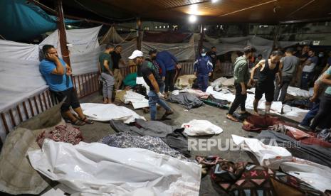 Orang-orang berkumpul di sekitar jasad warga Palestina yang meninggal dalam serangan Israel di Rumah Sakit Baptis Al-Ahli di Jalur Gaza, pada 17 Oktober 2023. 