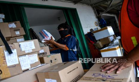 Pekerja menata barang yang akan dikirim melalui kereta api di Stasiun Pasar Senen, Jakarta Pusat, Senin (30/3/2020). Jasa pengiriman logistik melalui kereta api menurun sekitar 15 hingga 30 persen sebagai imbas dari wabah COVID-19 serta adanya kebijakan pembatalan jadwal perjalanan kereta api