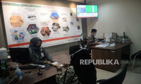 Nasabah melakukan transaksi di Bank BNI Syariah, Jakarta, Rabu (14/10). PT Bank BNI Syariah menyambut baik langkah positif upaya penggabungannya dengan dua bank syariah milik bank Himbara lain, yakni PT Bank BRIsyariah Tbk, PT Bank Syariah Mandiri serta berharap bank syariah hasil merger tersebut mampu mengoptimalkan potensi ekosistem halal, demi mewujudkan Indonesia sebagai produsen produk-produk halal dan menjadi tuan rumah di negeri sendiriPrayogi/Republika