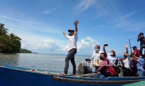 Menteri Pendidikan dan Kebudayaan Nadiem Makarim (kiri) melambaikan tangan kepada guru, siswa dan warga usai mengunjungi SD Inpres 56 Kepulauan Soop, Kota Sorong, Papua Barat, Jumat (12/2/2021). Mendikbud melakukan tatap muka dengan guru di daerah Terpencil, Terdepan dan Terluar (3T) sekaligus menyosialisasikan kebijakan kenaikan dana BOS 30 persen di wilayah Papua- Papua Barat berdasarkan Indeks Kemahalan Konstruksi (IKK). 