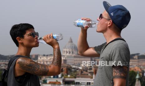 Turis minum air selama hari yang panas di teras Pincio di Villa Borghese Park, Roma, Italia, 11 Agustus 2021. Jumlah kota Italia dalam siaga merah karena potensi dampak panas terhadap kesehatan masyarakat akan meningkat dari empat menjadi 10 Agustus hingga 10 pada 11 12 Agustus, kata pemerintah.