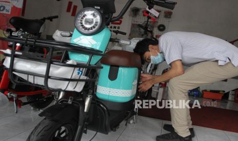 Seorang pramuniaga menyiapkan sepeda listrik atau e-bike di sebuah dealer di Malang, Jawa Timur, Rabu (21/9/2022). Penjual kendaraan listrik di kawasan itu mengatakan sejak tiga bulan terakhir permintaan sepeda listrik (e-bike) dan sepeda motor listrik meningkat dari rata-rata 35 unit menjadi kisaran 50 unit per bulan. 