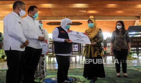 Gubernur Jawa Timur Khofifah Indar Parawansa (tengah) menyerahkan simbolis bantuan ventilator kepada rumah sakit rujukan COVID-19 di Sidoarjo, Pasuruan dan Mojokerto di Pendopo Delta Wibawa Sidoarjo, Jawa Timur, Rabu (16/9/2020). Dalam kesempatan itu Gubernur juga menyerahkan bantuan 26 ventilator kepada rumah sakit rujukan COVID-19 di Sidoarjo, Pasuruan, Mojokerto, dan bantuan berupa 16.000 masker kepada Koordinator Kabupaten Program Keluarga Harapan (PKH), Tenaga Kesejahteraan Sosial Kecamatan (TKSK) dan Tagana serta Bantuan Langsung Tunai Dana Desa (BLT DD) dan BUMDes. 