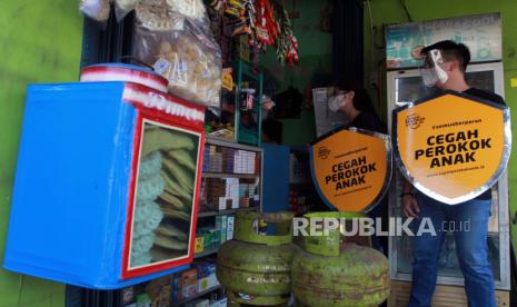 Dua relawan melakukan edukasi tentang bahaya merokok kepada pedagang saat kampanye 