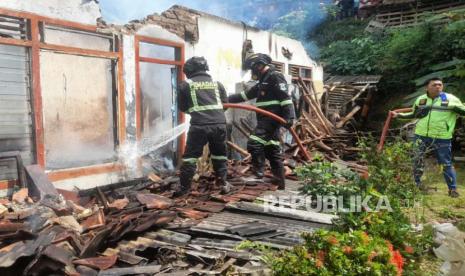 Petugas pemadam kebakaran menangani kebakaran rumah di Kampung Dukuh 2, Desa Dukuhmaja, Kecamatan Luragung, Kabupaten Kuningan, Jawa Barat, Sabtu (8/7/2023)