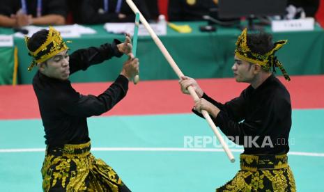 Pasangan pesilat ganda putra Papua Suhardin Ifu dan Lutfi Ebyanto memperagakan jurusnya saat bertanding pada final Pencak Silat kategori Seni Ganda Putra PON Papua di Gor Toware, Kabupaten Jayapura, Papua, Senin (11/10/2021). Pasangan ganda putra Papua Suhardin Ifu-Lutfi Ebyanto berhasil meraih medali emas dengan poin 574 sementara medali perak raih pasangan pesilat Bali I Putu Nyoman Wiraguna-I Kadek Nyeneng Jaya Wiguna dengan poin 563 dan perunggu diraih pasangan pesilat Jawa Barat Oki Oktavian-Zean Nurdin dengan poin 561. 