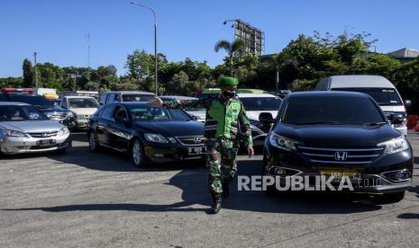 Anggota TNI mengimbau pengendara untuk memutar balik saat penyekatan kendaraan di gerbang keluar Tol Pasteur, Kota Bandung, Selasa (6/7). Penyekatan tersebut merupakan tindak lanjut dari penerapan Pemberlakuan Pembatasan Kegiatan Masyarakat (PPKM) Darurat Jawa dan Bali yang ditujukan untuk menekan mobilitas kendaraan agar tidak masuk ke wilayah Kota Bandung demi mencegah penyebaran Covid-19. Foto: Republika/Abdan Syakura