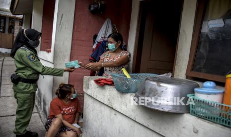 Petugas linmas membagikan masker saat sosialisasi perpanjangan Pemberlakuan Pembatasan Kegiatan Masyarakat (PPKM) Skala Mikro di Cimahi Tengah, Kota Cimahi, beberapa waktu lalu.