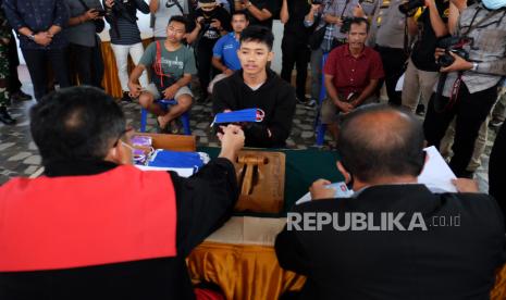 Seorang warga pelanggar protokol kesehatan mengikuti sidang Operasi Yustisi, di Medan, Sumatera Utara, Selasa (15/9/2020). Sidang Operasi Yustisi dalam rangka peningkatan disiplin dan penegakan hukum protokol kesehatan dalam upaya pencegahan penyebaran COVID-19 tersebut, memberikan sanksi kepada pelanggar yakni dengan menahan KTP selama tiga hari dan menyapu jalan bagi warga yang tidak memiliki KTP. 