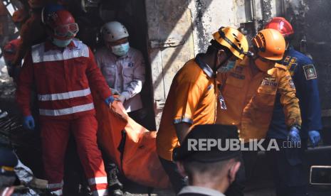 Petugas gabungan dari BPBD, PMI dan relawan mengangkat sesosok jasad ketika terjadi kebakaran gudang toko perabotan rumah tangga di Jalan Tugu, Jati Kramat, Bekasi, Jawa Barat, Rabu (3/7/2024). Kebakaran yang menewaskan lima orang penghuni rumah itu penyebabnya masih dalam penyelidikan pihak terkait. 