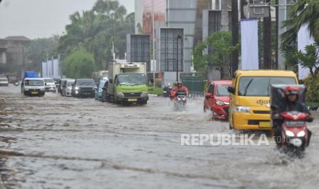 Kendaraan menerobos genangan air yang merendam di Jalan Boulevard Raya, Kelapa Gading, Jumat (22/3/2024). Badan Penanggulangan Bencana Daerah (BPBD) Jakarta mengumumkan, terjadi banjir di sebelas ruas jalan Jakarta. Hujan yang mengguyur wilayah Jakarta semalam juga mengakibatkan di Jalan Boulevard Raya tersebut terendam dengan ketinggian 20 cm.