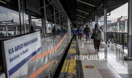 Calon penumpang berjalan menuju rangkaian KA Argo Parahyangan di Stasiun Bandung, Kota Bandung, Jumat (9/12/2022). 