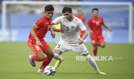 Pesepak bola Timnas Indonesia U-24 Ramadhan Sananta (kiri) melewati pesepak bola Uzbekistan Mukmammadkodir khamraliev pada babak 16 besar Asian Games 2022 