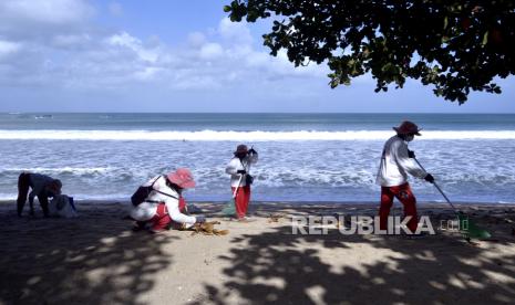 Pemerintah Izinkan Turis 19 Negara Masuk Bali Mulai Besok. Petugas membersihkan kawasan wisata Pantai Kuta yang sebelumnya ditutup di Badung, Bali, Rabu (8/9/2021). Gubernur Bali Wayan Koster mengizinkan Daya Tarik Wisata (DTW) alam, budaya, buatan, spiritual dan desa wisata di Pulau Dewata untuk mulai melakukan uji coba pembukaan kawasan bagi wisatawan dengan kapasitas pengunjung maksimal 50 persen, menerapkan protokol kesehatan yang ketat serta mengimplementasikan aplikasi PeduliLindungi. 