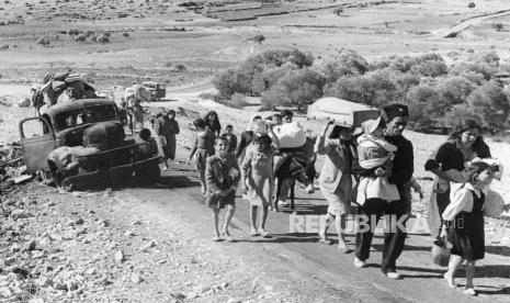 FILE - Palestinian villagers who fled from their homes during fighting between Israeli and Arab troops, on Nov. 4, 1948. (