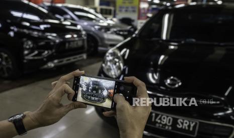 Pedagang memotret mobil bekas yang dipasarkan melalui media daring di Bursa Mobil Bekas WTC Mangga Dua, Jakarta, Rabu (23/9/2020). Pedagang mobil bekas setempat menolak usulan relaksasi pajak pembelian mobil baru sebesar nol persen yang diajukan Kementerian Perindustrian ke Kementerian Keuangan karena dapat menyebabkan harga mobil bekas dipasaran turun drastis. 