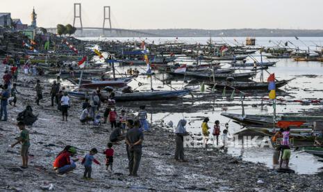 Warga bermain di pesisir pantai batu-batu Kenjeran, Surabaya, Jawa Timur