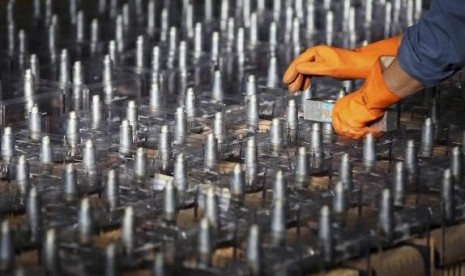 An employee prepares FIAMM batteries, in this photo illustration taken at the battery maker's factory in Avezzano, near L'Aquila, November 28, 2014.