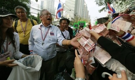  Supporters hand money to Thai anti-government protest leader Suthep Thaugsuban during a march Thursday, Jan. 23, 2014, in Bangkok, Thailand. 