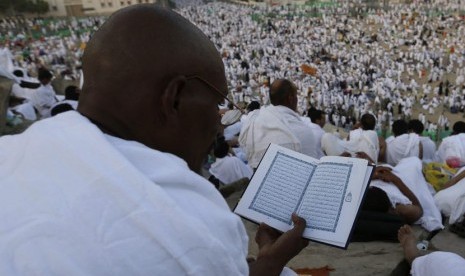  Seorang jamaah haji membaca kitab suci Alquran di puncak Jabal Rahmah, Arafah (ilustrasi).  