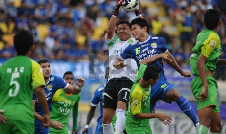   Pemain Persib Ahmad Jupriyanto (kanan) berebut bola dengan pemain Persebaya Jendry Pitoy (kiri) pada laga lanjutan delapan besar group L Indonesia Super League di Stadion Si Jalak Harupat, Kabupaten Bandung, Rabu(22/10).(foto: Septianjar Muharam)