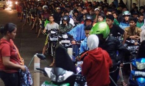 Pengendara motor antre mengisi bahan bakar minyak (BBM) bersubsidi jenis bensin di SPBU Lubukbuaya, Padang, Sumbar, Senin (17/11) malam.  (Antara/Iggoy el Fitra)