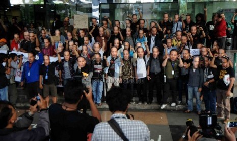  Piuluhan warga yang tergabung dalam Gerakan Rakyat Melawan Korupsi mengenakan topeng berwajah Wakil Ketua KPK, Bambang Widjojanto saat menggelar aksi di depan Gedung KPK, Jakarta, Sabtu (24/1). (Republika/Agung Supriyanto)