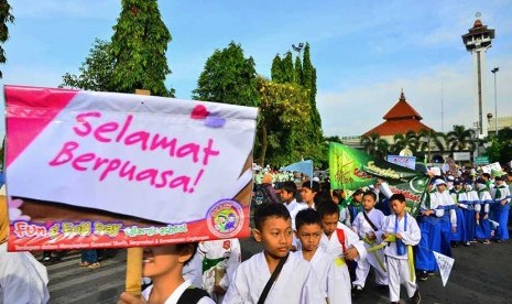   Sejumlah peserta pawai membawa atribut tulisan menyambut bulan puasa di depan alun-alun Kudus, Jawa Tengah, Selasa (9/6). (Antara/Yusuf Nugroho)