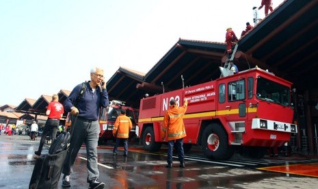  Petugas pemadam kebakaran melakukan pendinginan Gate 3 keberangkatan Luar Negeri yang terbakar di Terminal 2E Bandara Soekarno Hatta, Tangerang, Banten, Ahad (5/7). (Antara/Muhammad Iqbal)