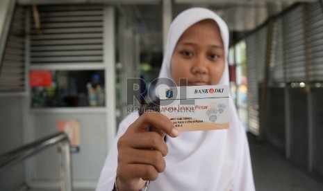  Seorang siswa SMPN 5 Jakarta menunjukkan Kartu Jakarta Pintar (KJP) di Halte Bus TransJakarta Pasar Baru, Jakarta, Senin (24/8). (Republika/Yasin Habibi)