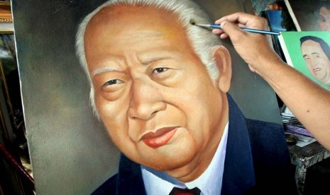 Seroang pelukis melukis wajah Presiden RI ke-2 Soeharto.