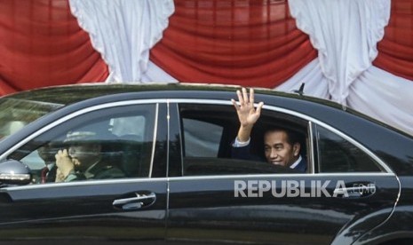 Presiden Terpilih Periode 2019-2024 Joko Widodo menyapa relawan saat akan menuju ke tempat pelantikan di Jakarta, Ahad (20/10).