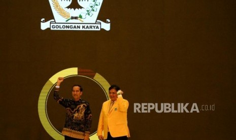 Presiden Joko Widodo bersama Ketua Umum Partai Golkar Airlangga Hartarto mengangkat tangan saat memperingati HUT ke-55 tahun Partai Golkar di Jakarta, Rabu (6/11).