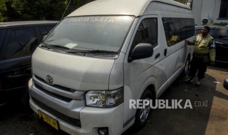 Kejari Depok Belum Terima Putusan PK Pengembalian Aset First Travel. Foto: Petugas berada di dekat mobil sitaan aset First Travel di Kejaksaan Negeri Depok, Jawa Barat, Senin (25/11).