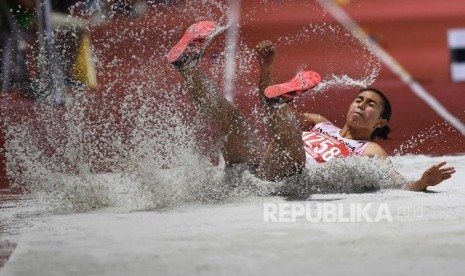 Atlet lompat jangkit Indonesia Maria Natalia Londa melompat pada pertandingan Lompat Jangkit Putri SEA Games ke-30 di Stadion Atletik New Clark, Filipina, Sabtu (7/12/2019).