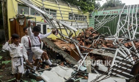 Sejumlah pelajar melewati kondisi kelas yang rusak di SDN Cirimekar 02, Cibinong, Bogor, Jawa Barat, Senin (6/1).