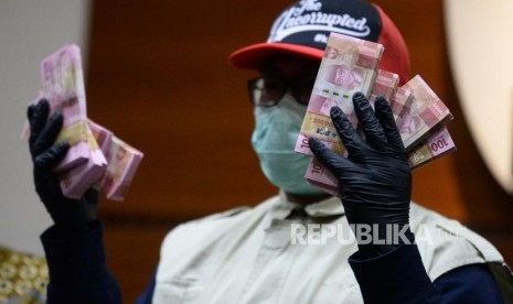 Penyidik KPK menunjukan barang bukti saat konferensi pers Operasi Tangkap Tangan (OTT) Bupati Sidoarjo di gedung KPK, Jakarta, Rabu (8/1).