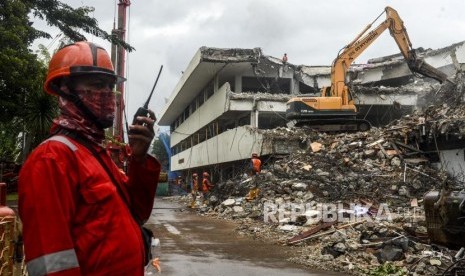 Pekerja membongkar gedung menggunakan alat berat di lokasi proyek revitalisasi kawasan Taman Ismail Marzuki (TIM) di Jakarta, Jumat (7/2).