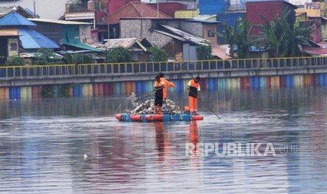 Tiga  orang petugas UPK Badan Air Dinas Lingkungan Hidup Provinsi DKI Jakarta dengan menggunakan plampung rakitan menyerok sampah di danau Podomoro Sunter Jakarta, Sabtu (8/2).Pemerintah Provinsi DKI Jakarta menerapkan tiga strategi untuk mengurangi jumlah tonase sampah yang diangkut ke tempat pembuangan sampah terpadu (TPST) Bantargebang saat pandemi virus corona (Covid-19). 