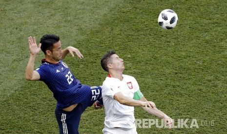 Pesepak bola Polandia Robert Lewandowski berebut bola dengan pesepak bola Jepang Maya Yoshida pada pertandingan grup H Piala Dunia 2018 di Volgograd Arena,Kamis (28/6).