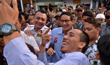 Relawan berfoto bersama Calon Wakil Presiden nomor urut 02 Sandiaga Uno (tengah) saat berkunjung di kawasan kuliner Jalan Roda, Manado, Sulawesi Utara, Senin (5/11/2018). 