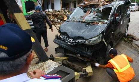 Petugas Dinas Perhubungan Provinsi Banten dan Polda Banten melakukan evakuasi bangkai kendaraan yang berserakan di sejumlah penginapan yang terhempas gelombang tsunami di Carita, Pandeglang, Banten, Selasa (25/12/2018).