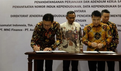 Chief Executive Officer (CEO) Bank Muamalat Achmad K. Permana (paling kiri) menandatangani perjanjian kerjasama dengan Direktorat Jenderal Dukcapil Kemendagri disaksikan oleh Direktur Fasilitasi Pemanfaatan Data dan Dokumen Kependudukan Ditjen Dukcapil Kemendagri Gunawan (kedua dari kiri), Jumat (28/12).