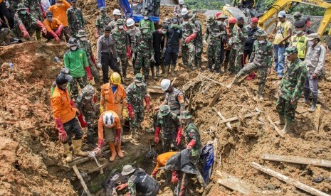 Petugas SAR gabungan bergotong royong berusaha mengeluarkan jenazah korban longsor yang tertimbun material tanah di Desa Sirnaresmi, Cisolok, Kabupaten Sukabumi, Jawa Barat, Sabtu (5/1/2019).