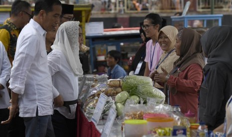 Presiden Joko Widodo (kiri) didampingi Ibu Negara Iriana Joko Widodo meninjau Program Mekaar / Ilustrasi 