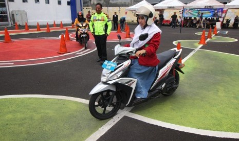 Pelajar mempraktekkan cara berkendara motor di area ujian praktek Surat Ijin Mengemudi (SIM) di Satuan Penyelenggara Administrasi SIM (Satpas) Colombo, Surabaya, Jawa Timur, Kamis (24/1/2019).