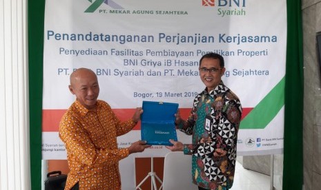 SEVP Bisnis Ritel & Jaringan BNI Syariah, Iwan Abdi (kanan) dan Direktur Utama PT Mekar Agung Sejahtera, Sengkono Dharmawan (kiri) usai penandatanganan Perjanjian Kerjasama (PKS) fasilitas pembiayaan kepemilikan rumah antara BNI Syariah dengan PT Mekar Agung Sejahtera (MAS Group), Selasa (19/3).